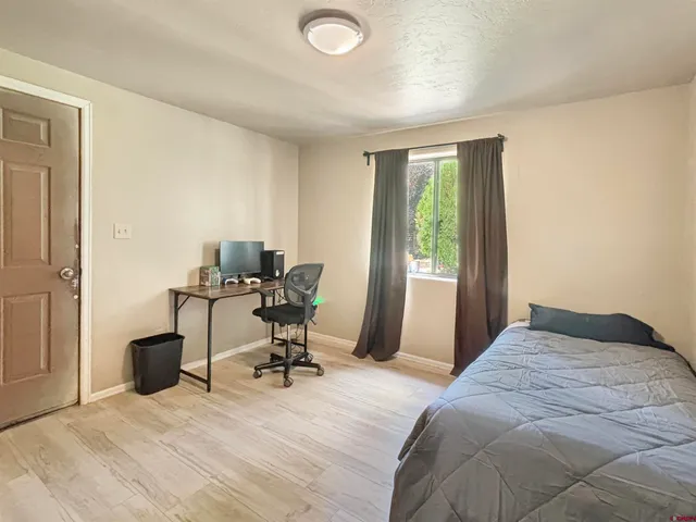 a bedroom with a bed and a table