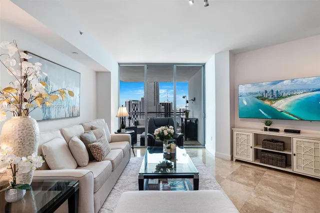 a living room with furniture a flat screen tv and a fireplace