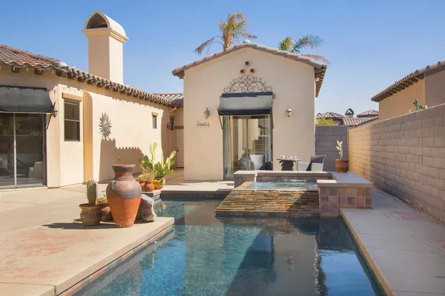 a living room with furniture kitchen view and a large window