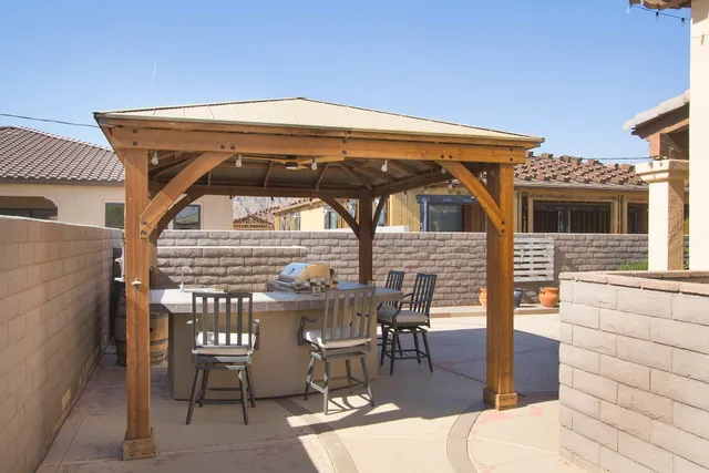 a living room with furniture a flat screen tv and kitchen view