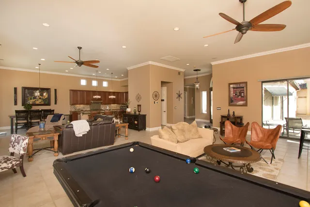 a spacious bedroom with a bed and a flat screen tv