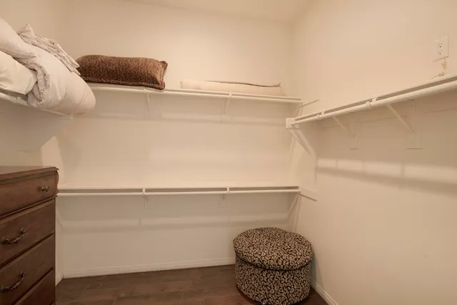 a bathroom with a granite countertop sink a mirror and a shower
