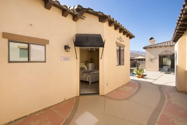 a view of a house with swimming pool and sitting area