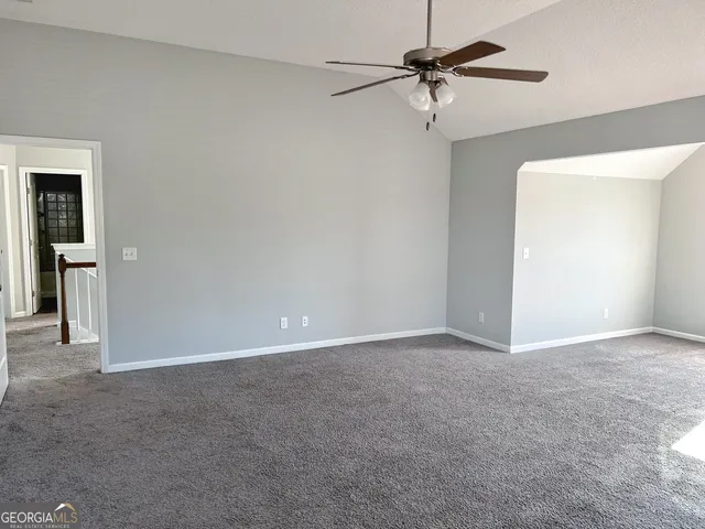 a view of an empty room with a fan