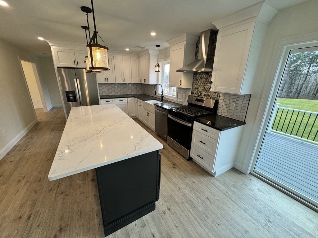 1479 Main Street Acushnet, MA 02743 - Photo 18 of 23 a kitchen with stainless steel appliances granite countertop a sink a stove a refrigerator and wooden floor