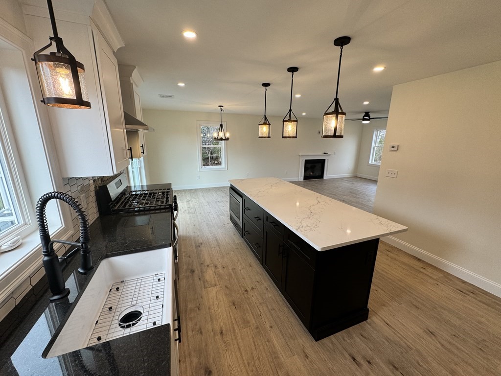 1479 Main Street Acushnet, MA 02743 - Photo 23 of 23 a kitchen with a refrigerator sink and wooden floor
