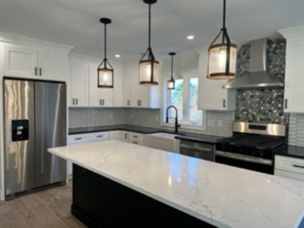 1479 Main Street Acushnet, MA 02743 - Photo 6 of 23 a kitchen with stainless steel appliances granite countertop a sink a stove and a refrigerator
