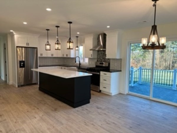 1479 Main Street Acushnet, MA 02743 - Photo 7 of 23 a large kitchen with kitchen island a large counter top a sink stainless steel appliances and cabinets