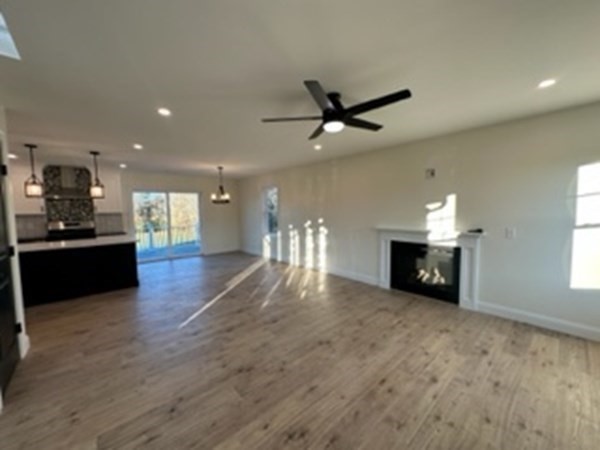 1479 Main Street Acushnet, MA 02743 - Photo 8 of 23 a view of an empty room with a fireplace and a window