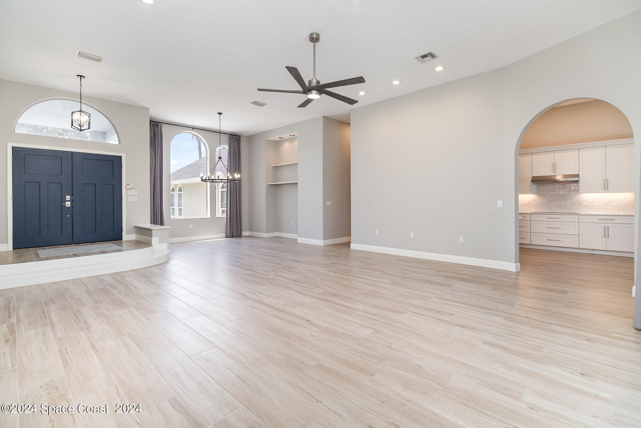 697 Spring Lake Drive Melbourne, FL 32940 - Photo 11 of 51 a view of a kitchen with wooden floor and a ceiling fan