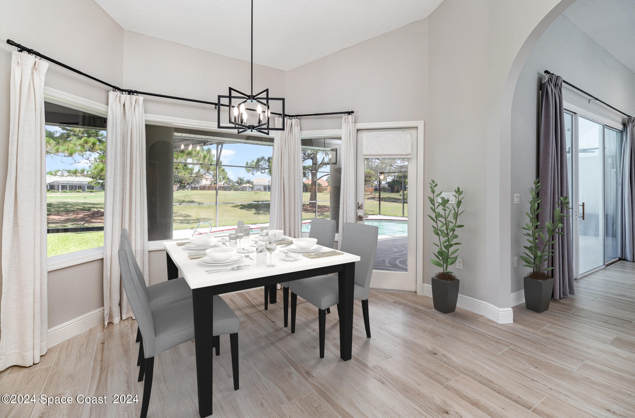 697 Spring Lake Drive Melbourne, FL 32940 - Photo 14 of 51 a view of a dining room with furniture window and wooden floor
