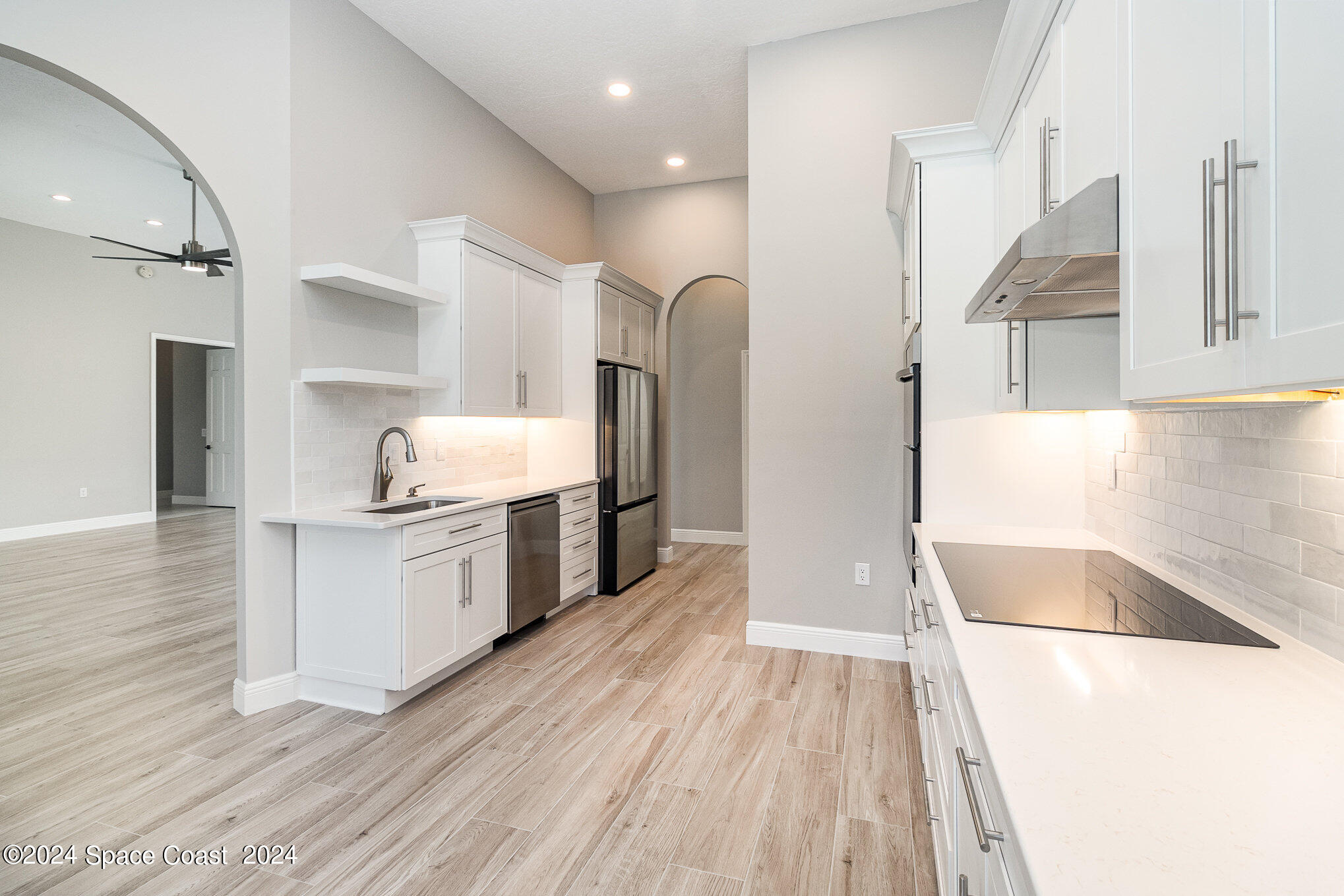 697 Spring Lake Drive Melbourne, FL 32940 - Photo 16 of 51 a kitchen with granite countertop a sink and a stove top oven