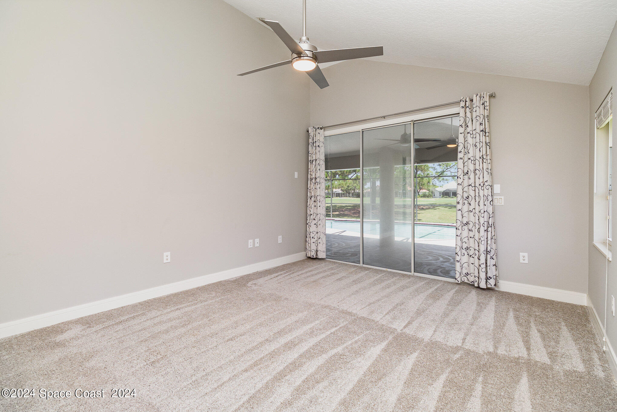 697 Spring Lake Drive Melbourne, FL 32940 - Photo 19 of 51 a view of an empty room with a window