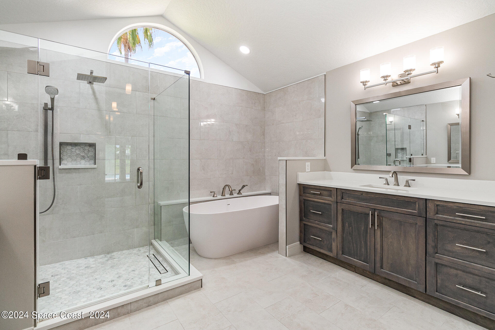 697 Spring Lake Drive Melbourne, FL 32940 - Photo 20 of 51 a bathroom with a bathtub shower sink mirror and toilet