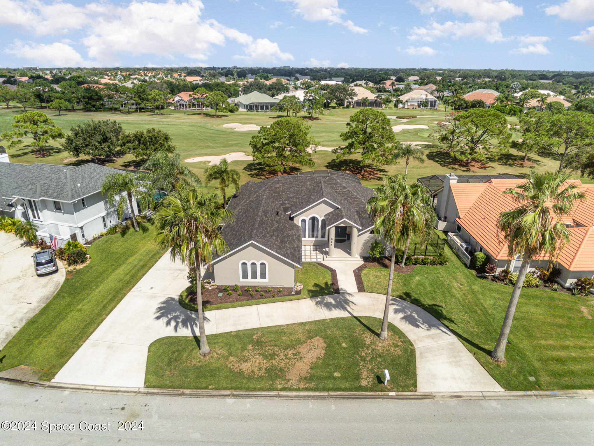 697 Spring Lake Drive Melbourne, FL 32940 - Photo 2 of 51 an aerial view of residential houses with outdoor space