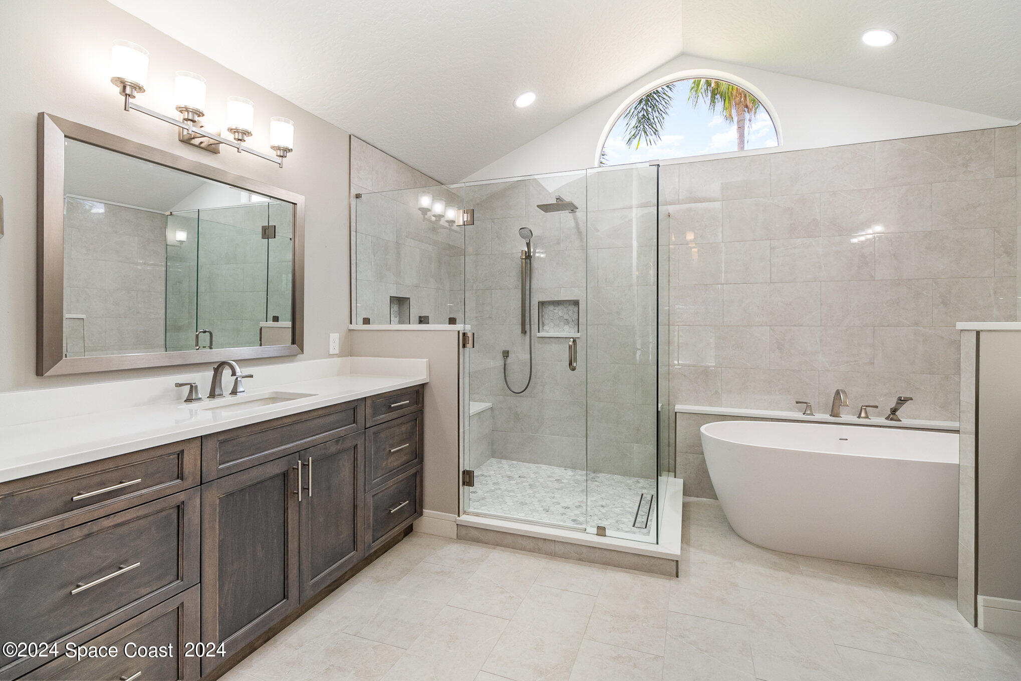 697 Spring Lake Drive Melbourne, FL 32940 - Photo 21 of 51 a spacious bathroom with a double vanity sink mirror and bathtub