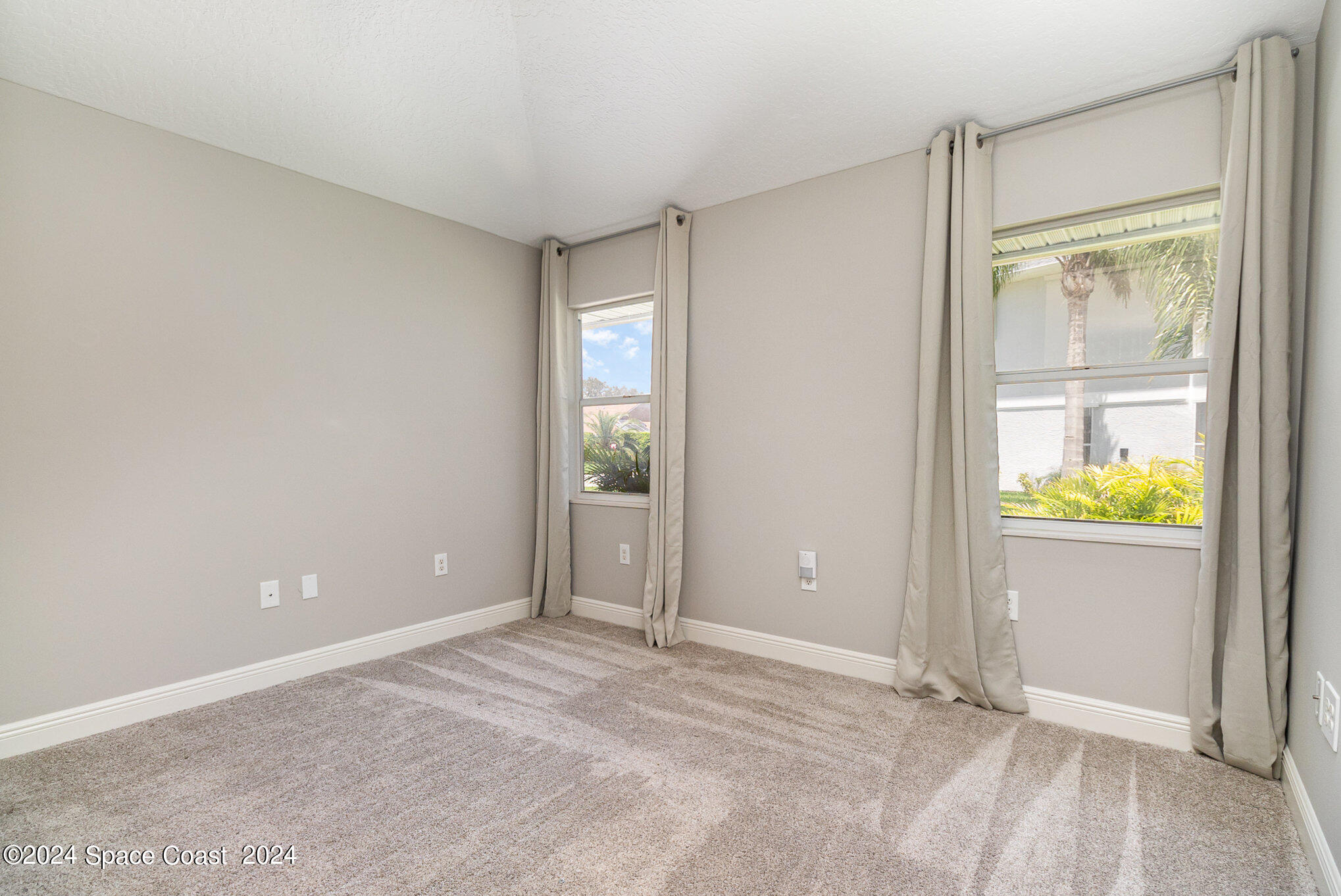 697 Spring Lake Drive Melbourne, FL 32940 - Photo 24 of 51 an empty room with window and wooden floor