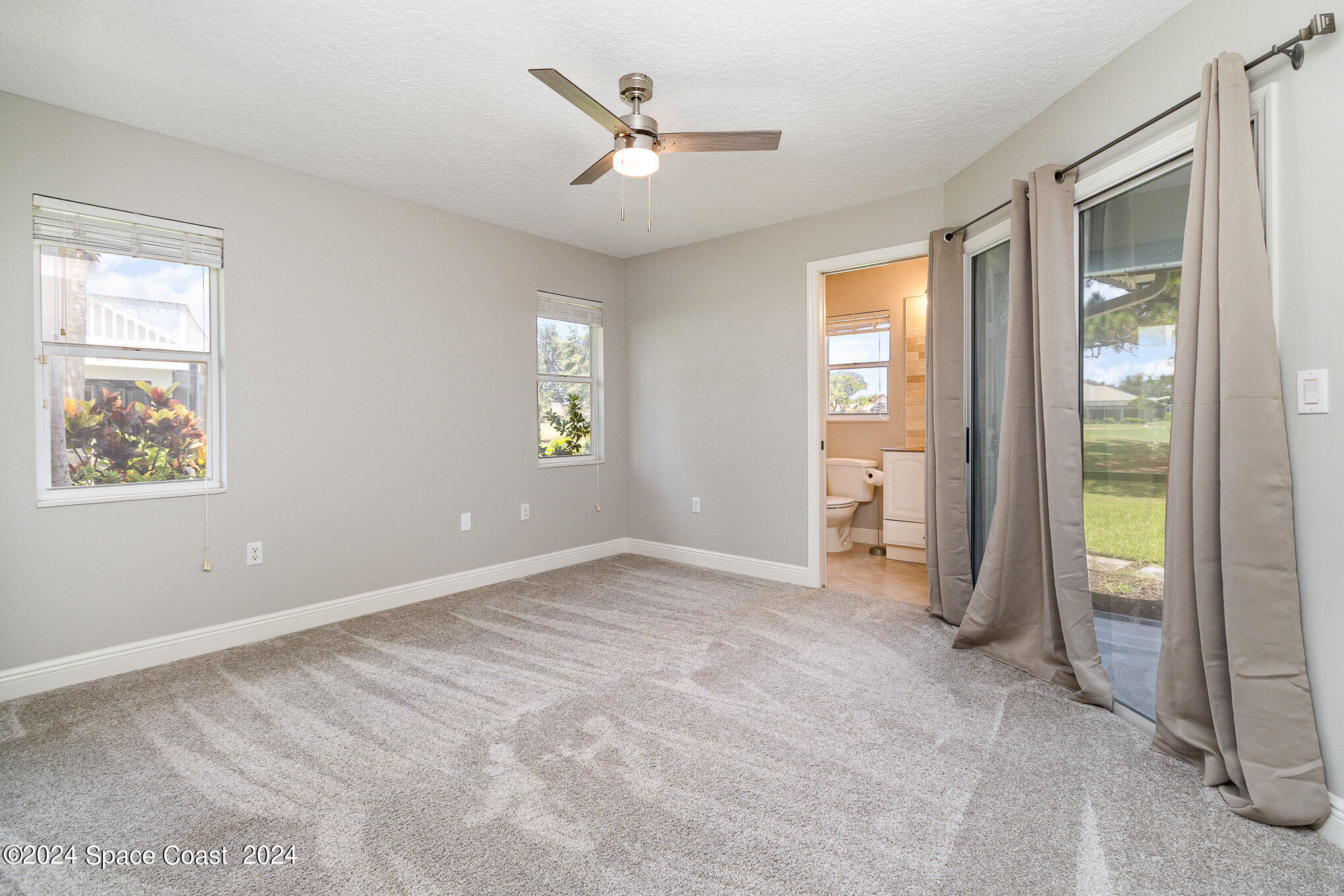 697 Spring Lake Drive Melbourne, FL 32940 - Photo 27 of 51 a view of an empty room with a window