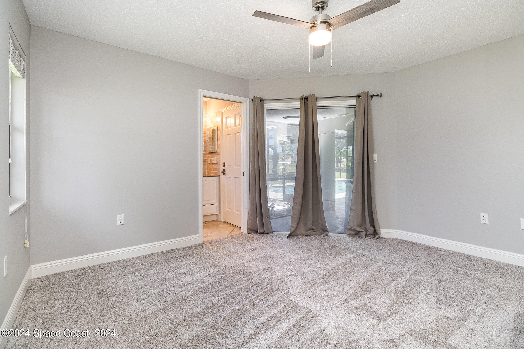697 Spring Lake Drive Melbourne, FL 32940 - Photo 28 of 51 wooden floor in an empty room with a window