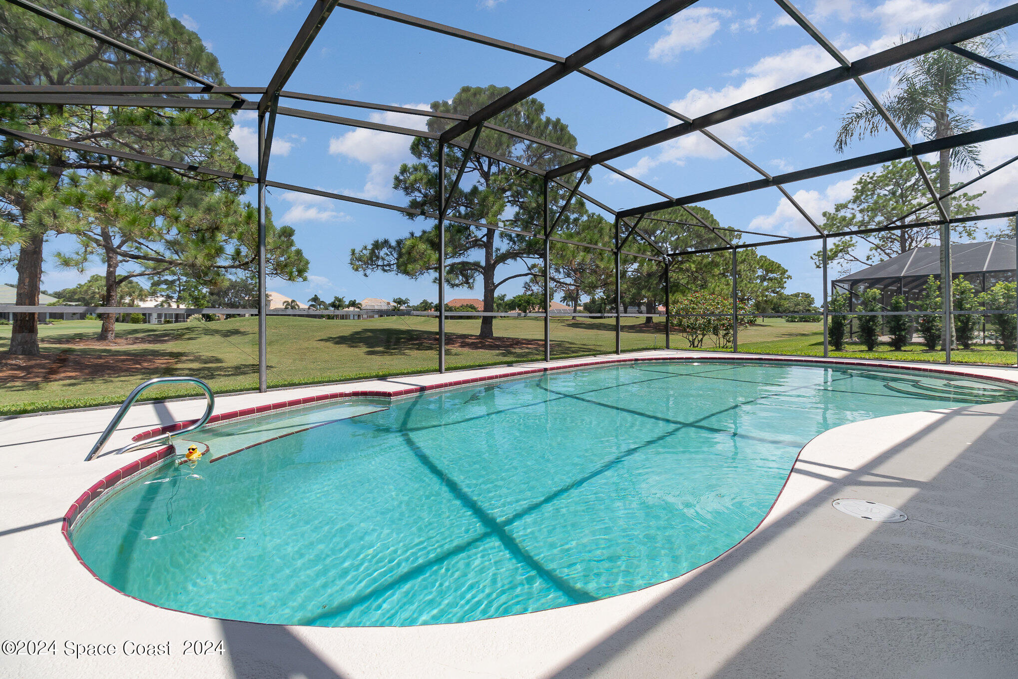 697 Spring Lake Drive Melbourne, FL 32940 - Photo 35 of 51 a view of a swimming pool with a yard