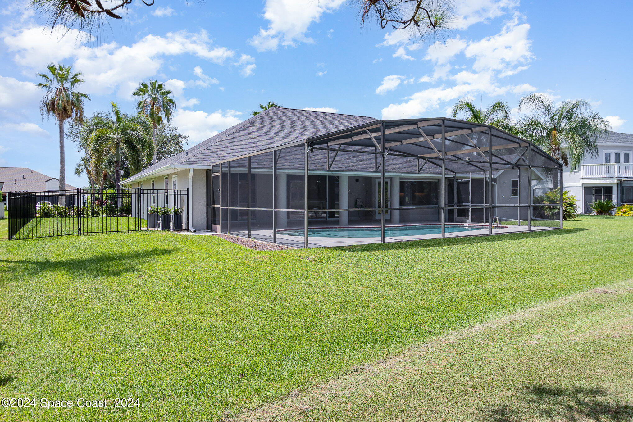 697 Spring Lake Drive Melbourne, FL 32940 - Photo 37 of 51 a view of a house with a backyard and a patio