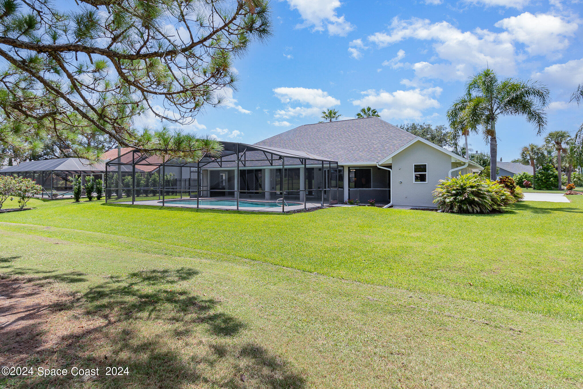 697 Spring Lake Drive Melbourne, FL 32940 - Photo 38 of 51 a view of a house with swimming pool and a yard