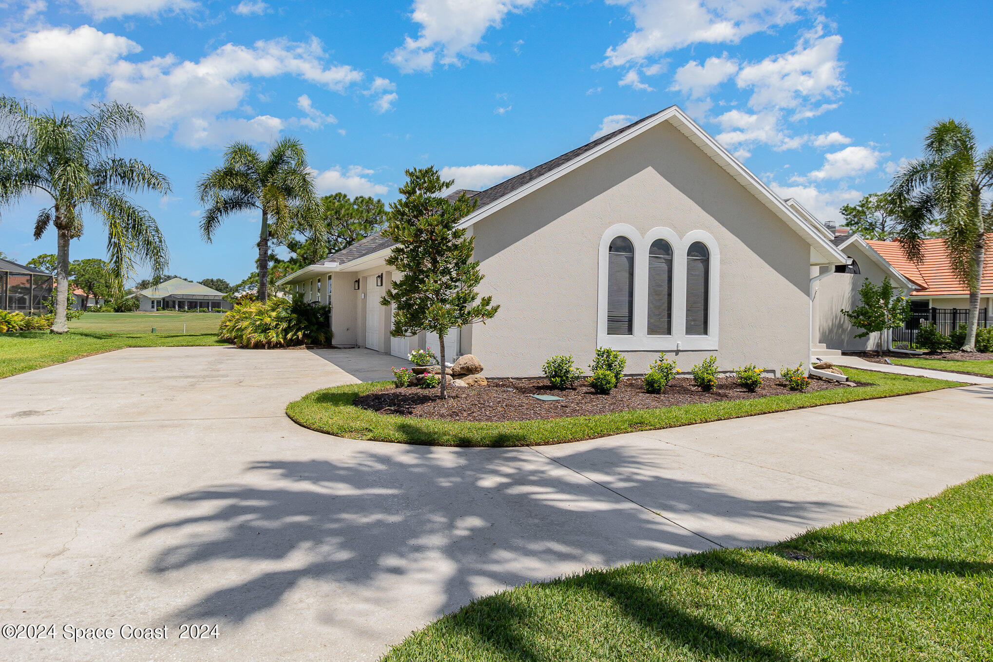 697 Spring Lake Drive Melbourne, FL 32940 - Photo 4 of 51 a front view of a house with a yard and garage
