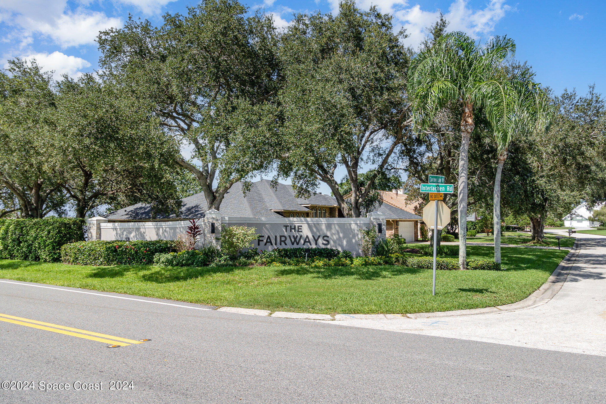 697 Spring Lake Drive Melbourne, FL 32940 - Photo 45 of 51 a view of a house with a big yard and large trees