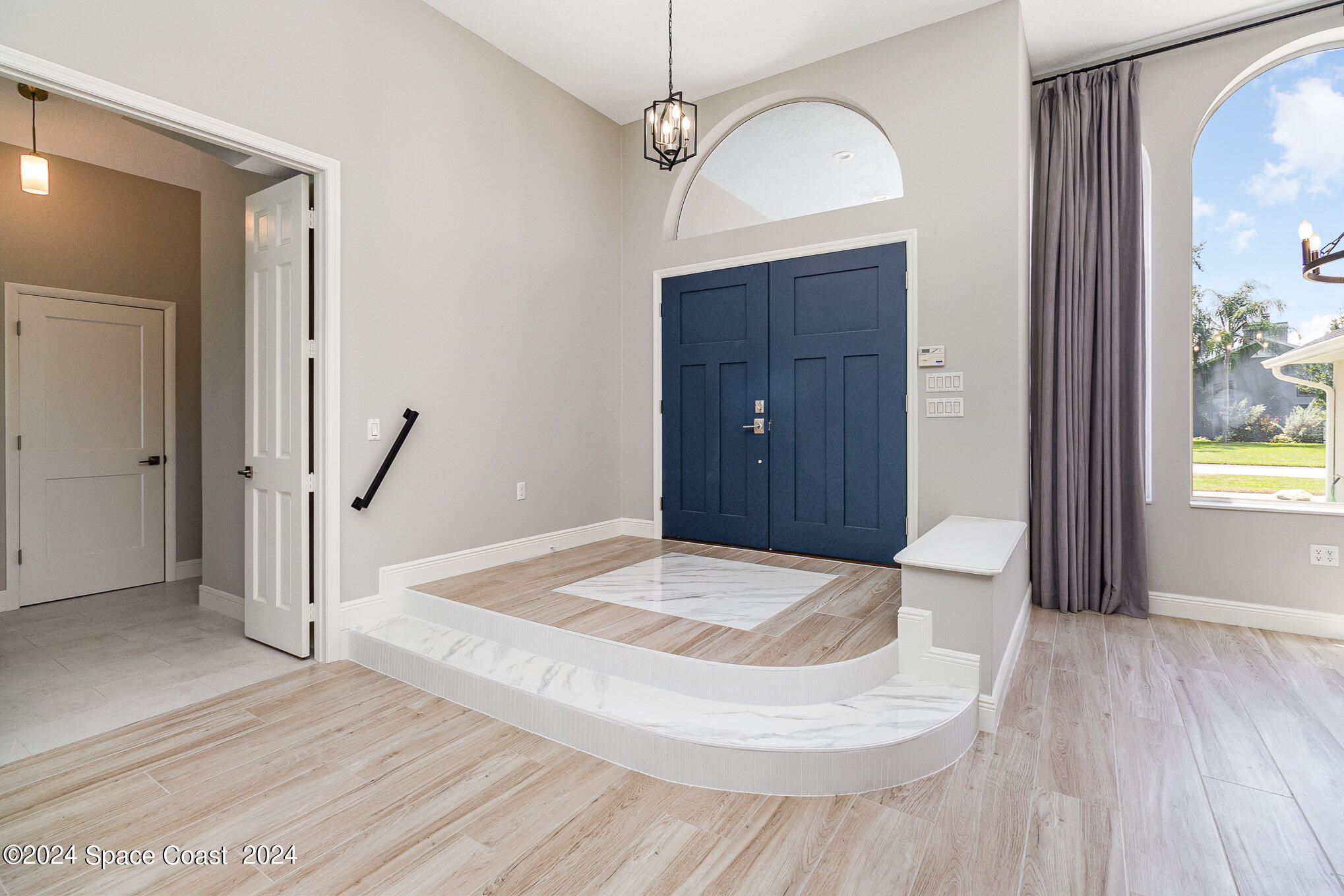 697 Spring Lake Drive Melbourne, FL 32940 - Photo 6 of 51 a view of a hallway view with wooden floor and staircase