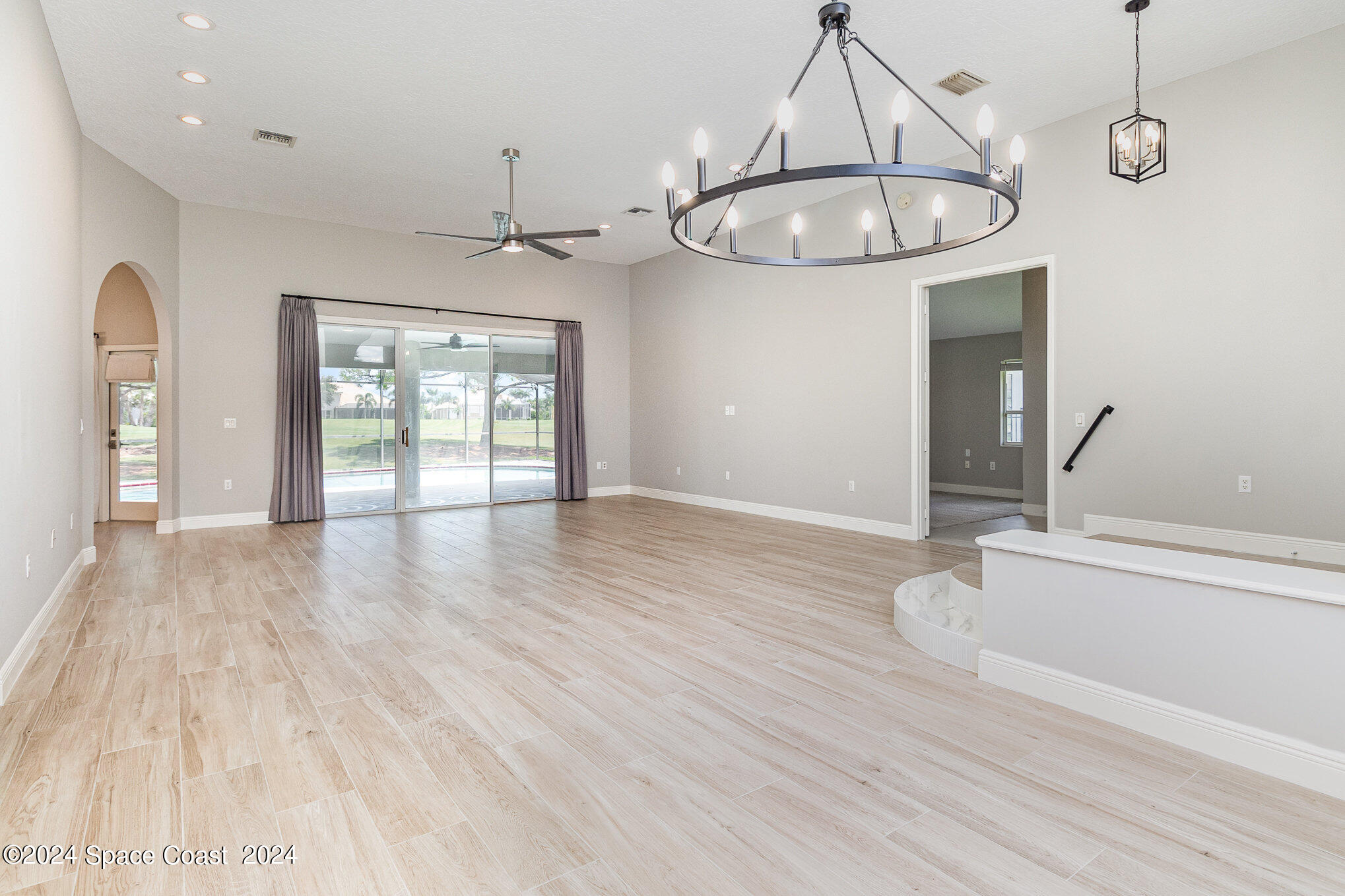 697 Spring Lake Drive Melbourne, FL 32940 - Photo 9 of 51 wooden floor in an empty room with a window