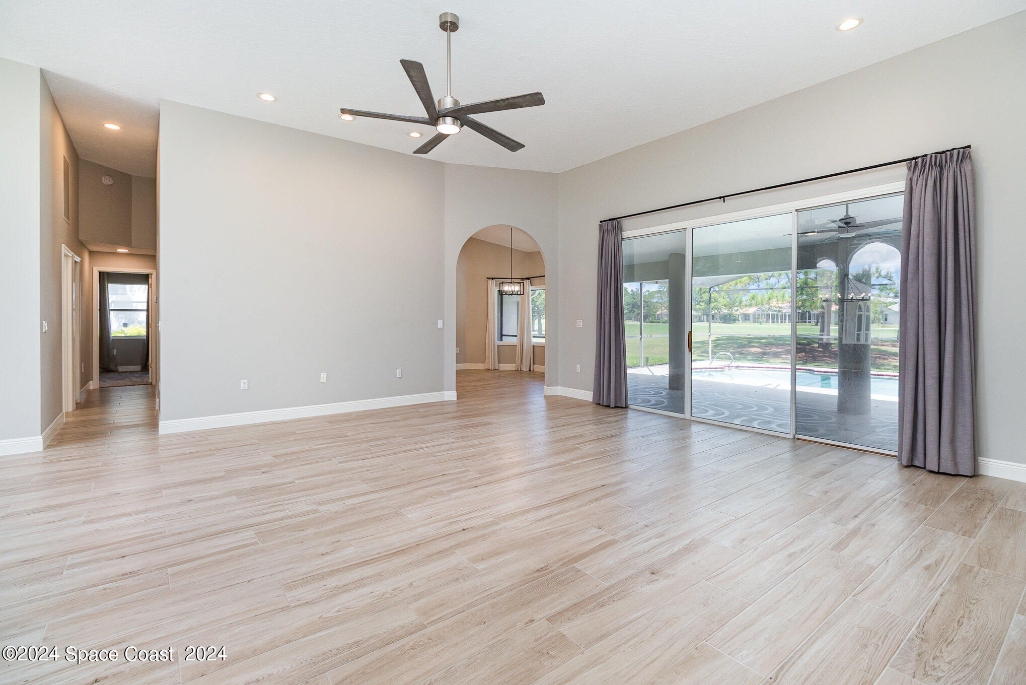 697 Spring Lake Drive Melbourne, FL 32940 - Photo 10 of 51 wooden floor in an empty room with a window