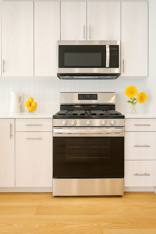 98 Prescott Street, Unit 2C Boston, MA 02128 - Photo 5 of 15 a kitchen with stainless steel appliances a stove and a microwave