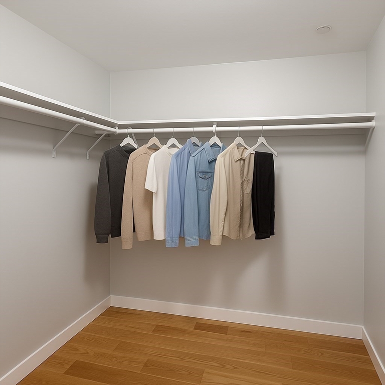 98 Prescott Street, Unit 2C Boston, MA 02128 - Photo 6 of 15 a view of walk in closet with clothes and white walls
