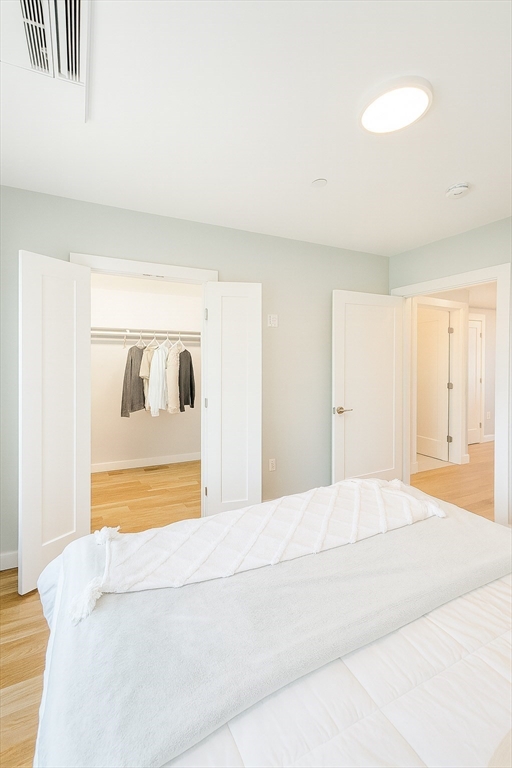 98 Prescott Street, Unit 2C Boston, MA 02128 - Photo 10 of 15 a bedroom with a bed and a dresser