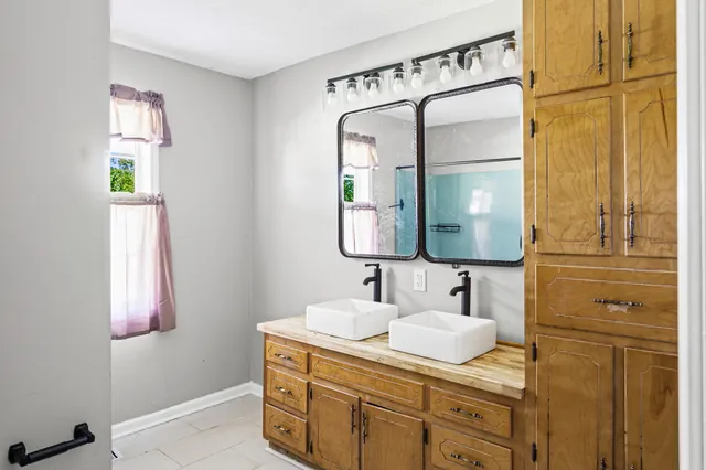 a bathroom with a sink vanity and a mirror