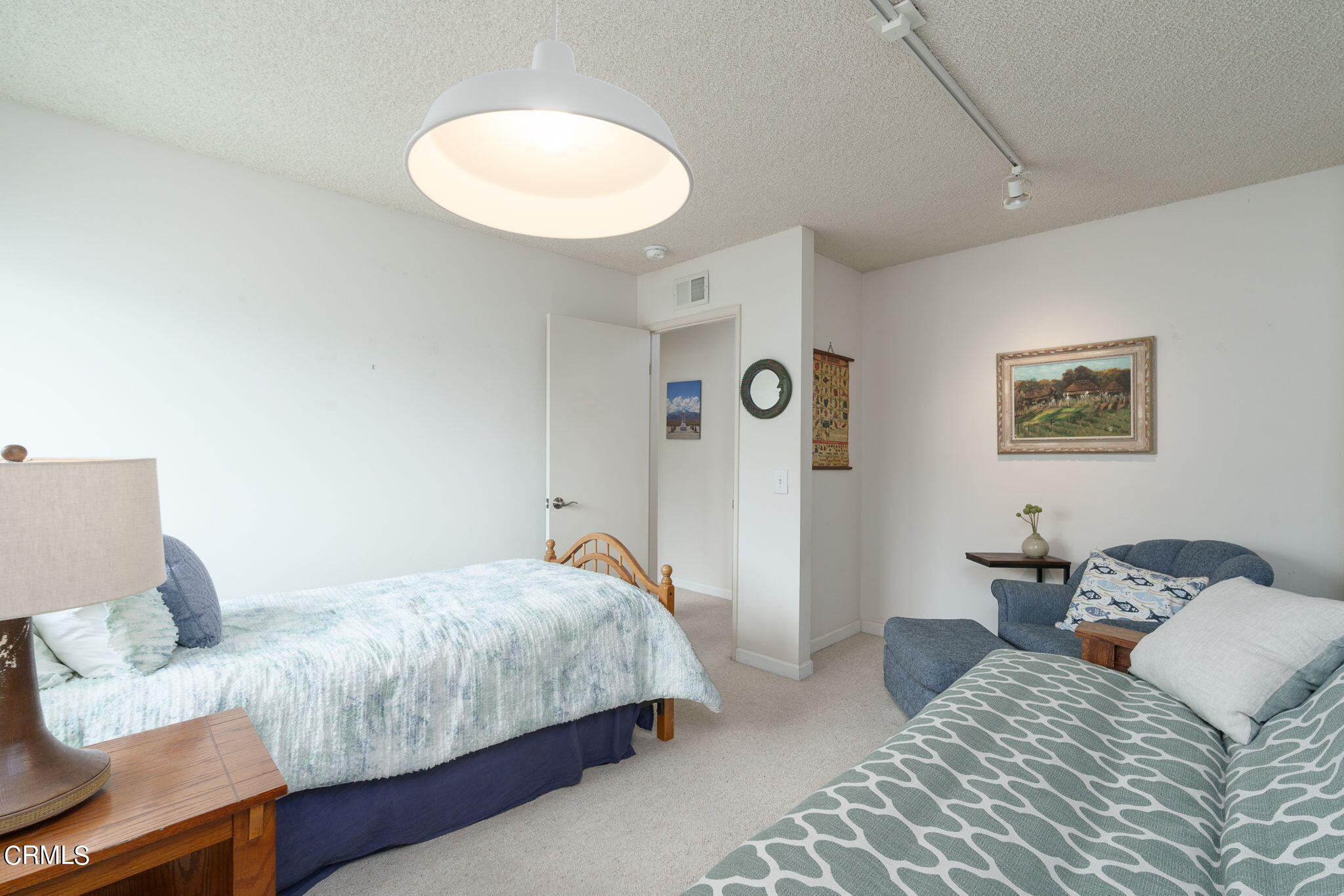 3225 Harbor Boulevard Oxnard, CA 93035 - Photo 17 of 34 a bedroom with a bed and a lamp