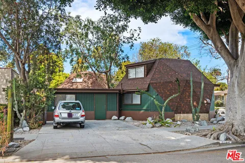 an aerial view of a house with garden space and street view