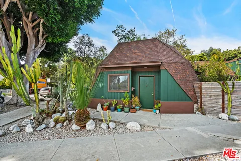 a backyard of a house with table and chairs