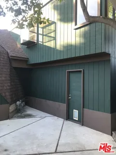 a view of a chairs and table in the backyard