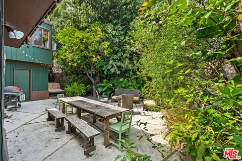 an outdoor sitting area with furniture and garden view