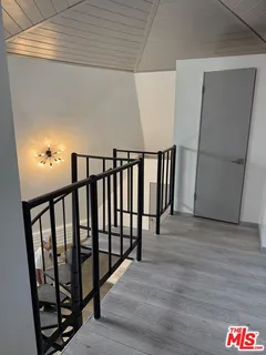 a view of a room with stairs and a chandelier fan