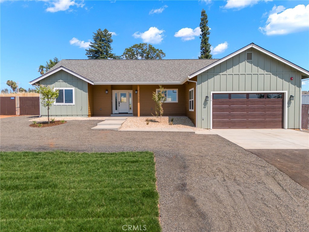 574 Hillcrest Drive Paradise, CA 95969 - Photo 1 of 26 a front view of a house with a yard and garage