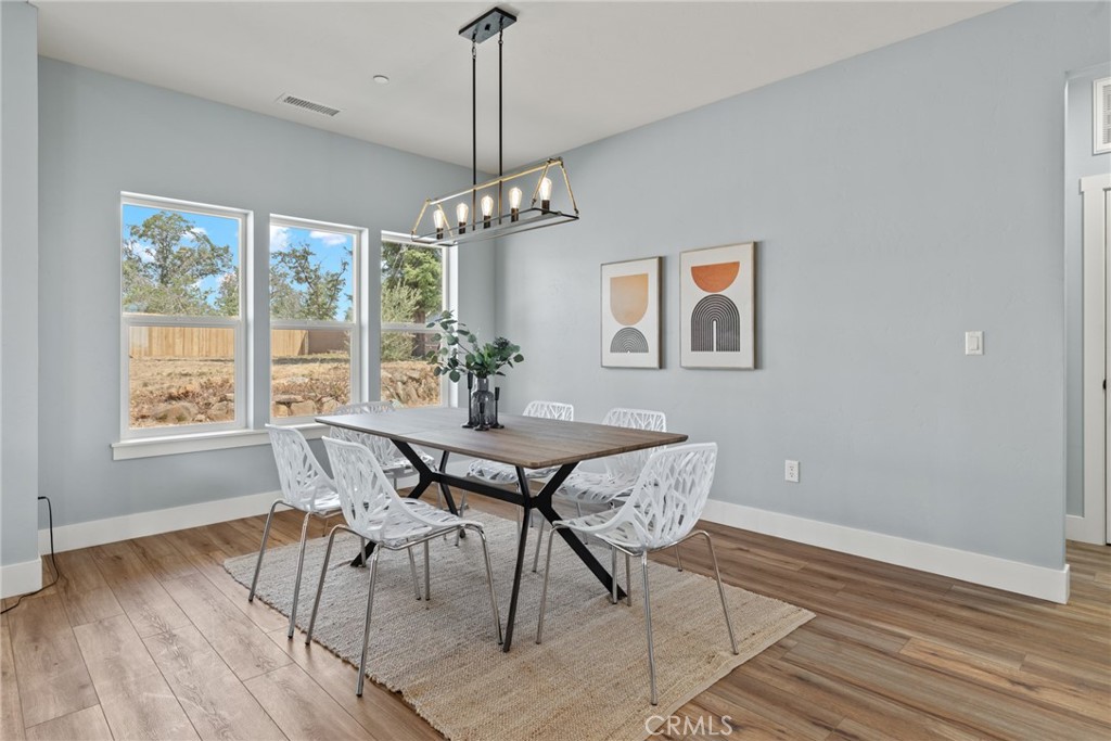 574 Hillcrest Drive Paradise, CA 95969 - Photo 12 of 26 a view of a dining room with furniture window and wooden floor