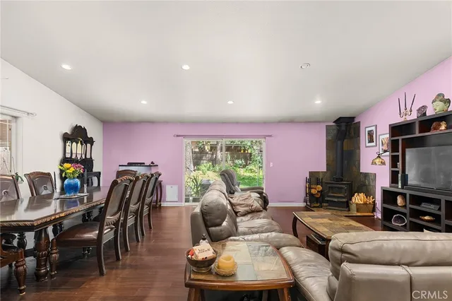 a living room with furniture a large window and a flat screen tv