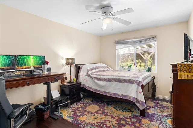 a view of a workspace with furniture and wooden floor