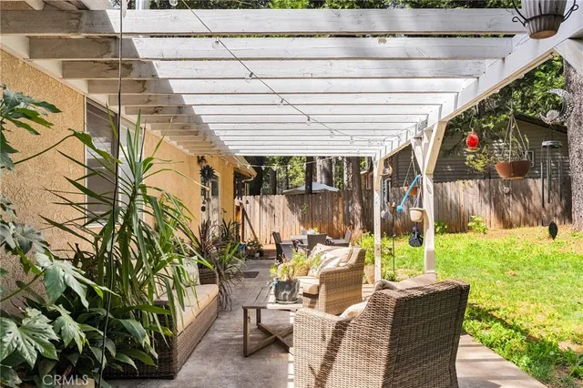 a front view of a house with a garden and trees