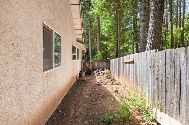 a view of a patio with table and chairs potted plants with large tree