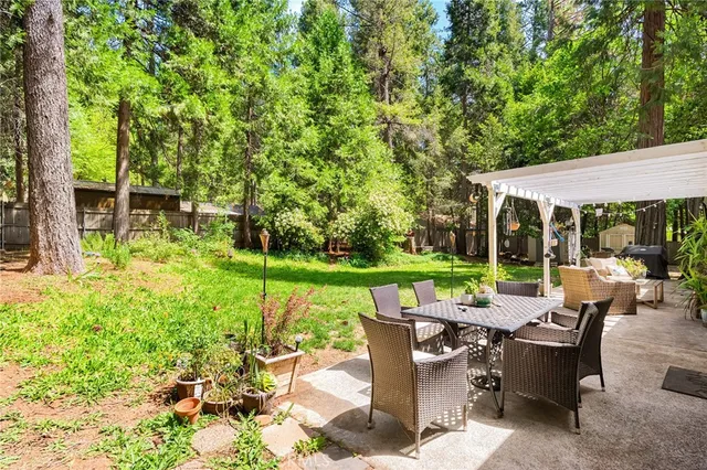 a backyard of a house with table and chairs
