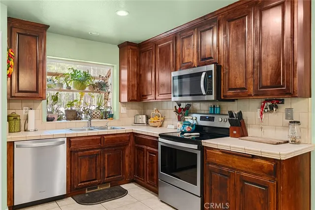 a kitchen with a sink stove and microwave
