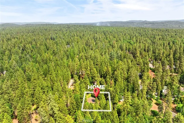 a view of a backyard with table and chairs and potted plants